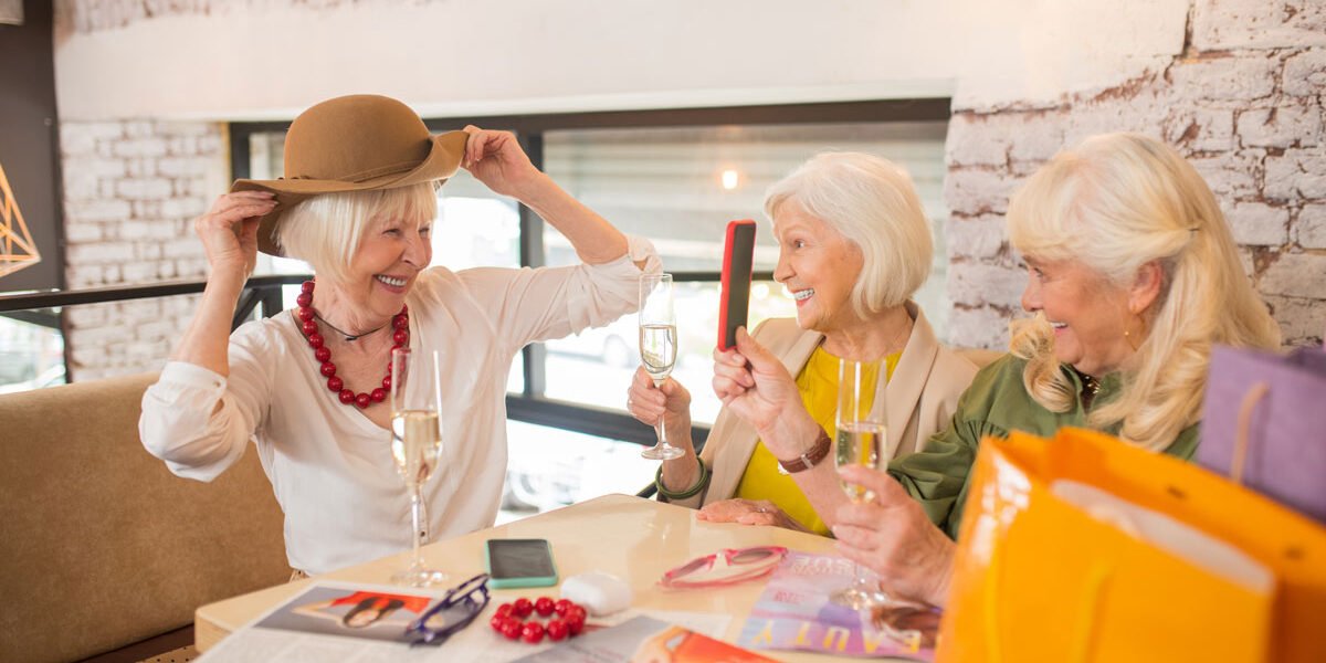 new-hat-women-sitting-looking-excited-while-trying-new-hat