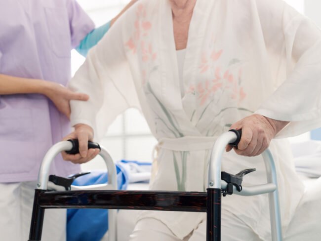 caregiver-assisting-a-patient-at-the-retirement-ho-2022-10-21-20-45-19-utc