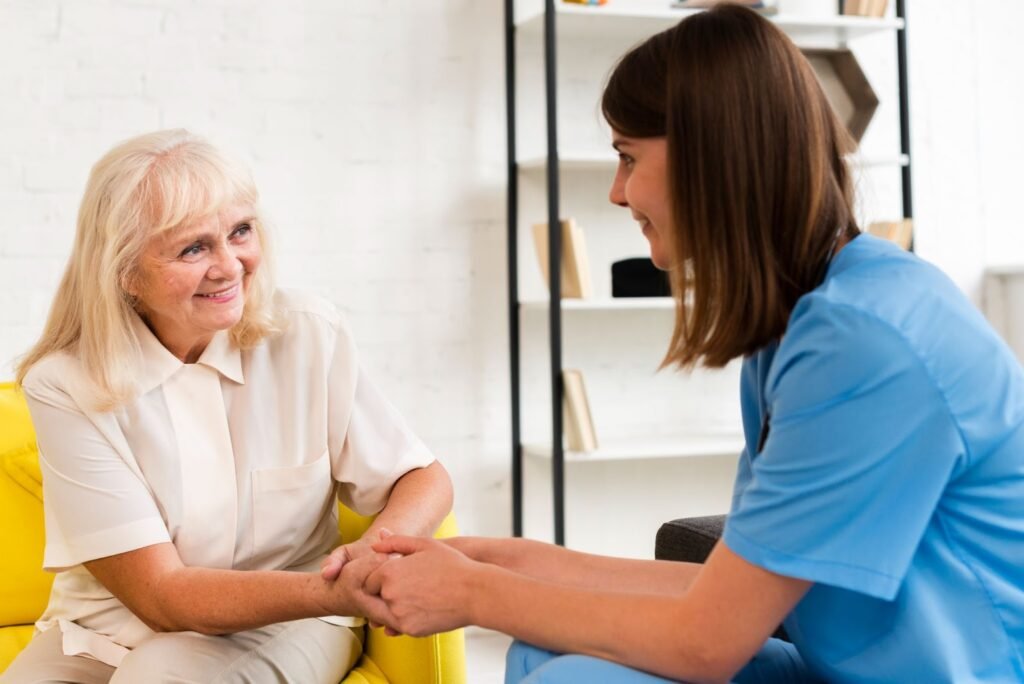 senior and nurse holding hands