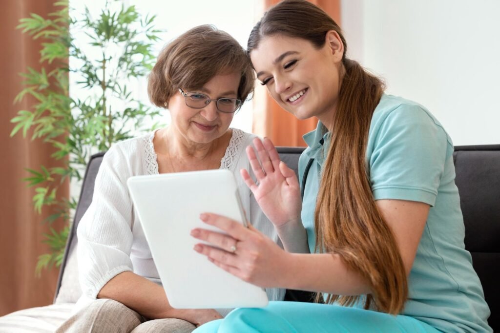 Caregiver helps senior with online communication