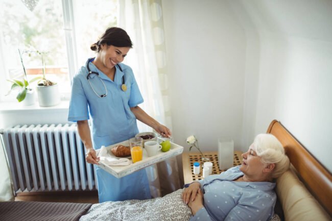 nurse-serving-breakfast-senior-woman (1)