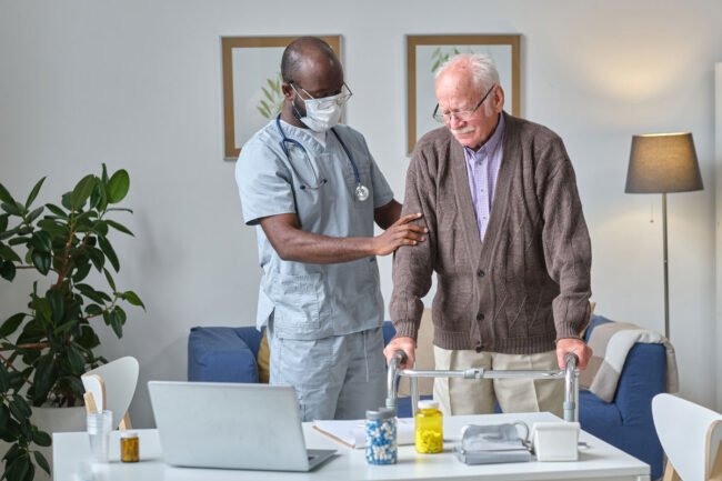 senior-man-using-walkers-while-visiting-his-doctor-hospital-doctor-examining-him